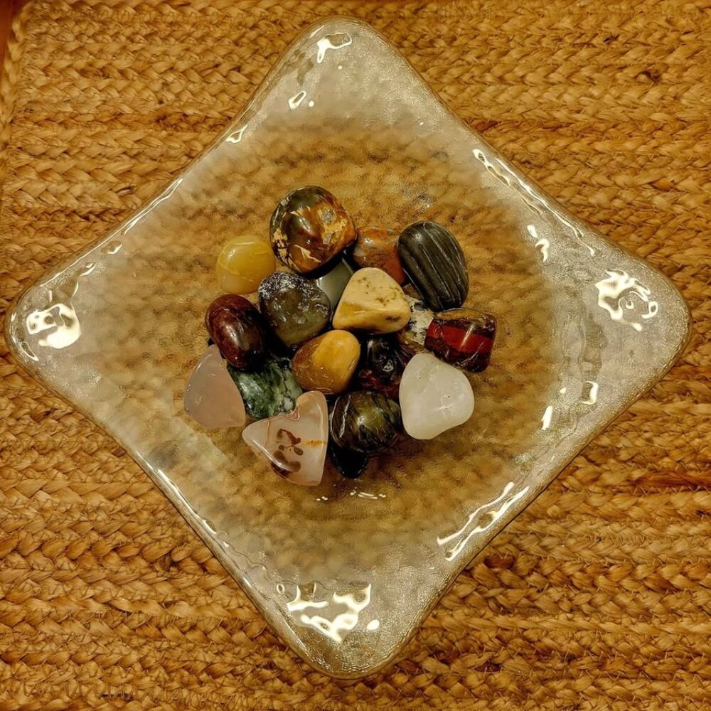 Polished Rocks, Agates, Jasper, and Petrified Wood Displayed In A Glass Dish